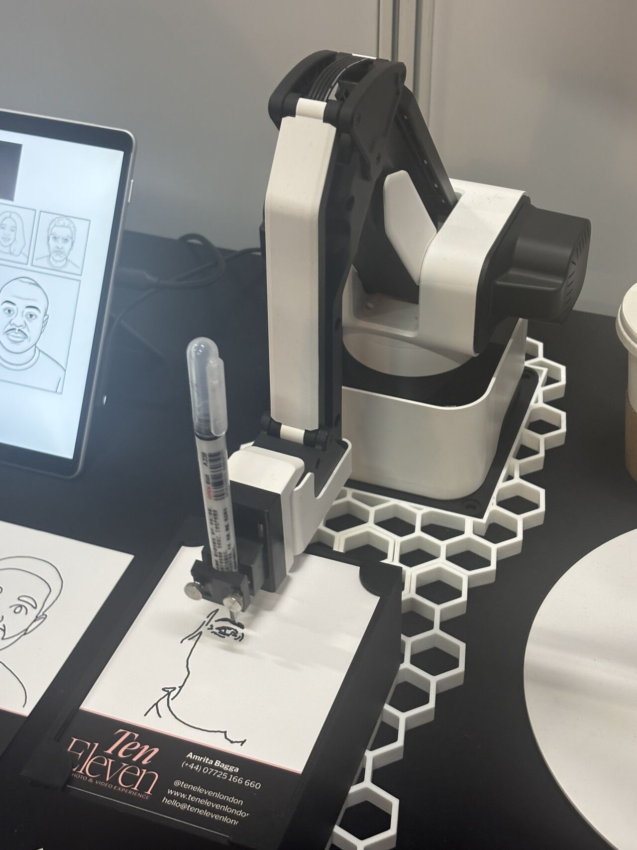 Close-up of a TenEleven AI sketch robot drawing a portrait.