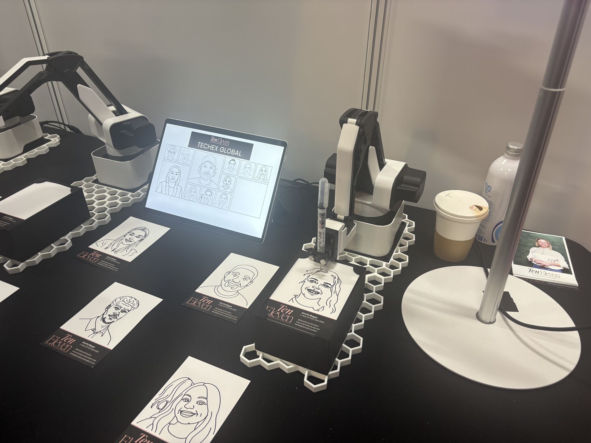 TenEleven sketch station with tablet previews and completed line portraits.